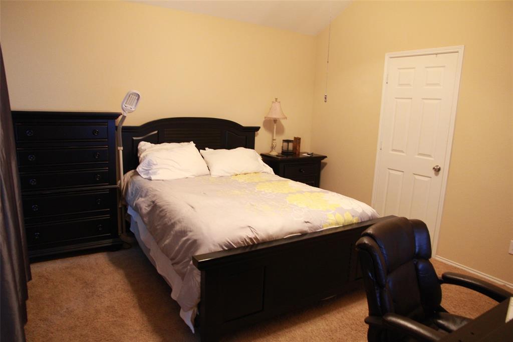 13153 Fencerow Road Fort Worth, TX 76244 - Photo 7 of 16 Carpeted bedroom featuring a vaulted ceiling and neutral wall tones
