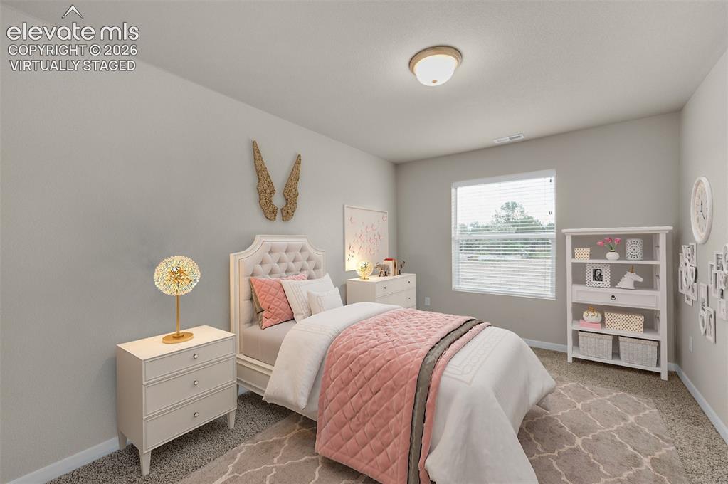 6644 Rawhide Rdg View Colorado Springs, CO 80915 - Photo 14 of 26 a bedroom with a bed and a window
