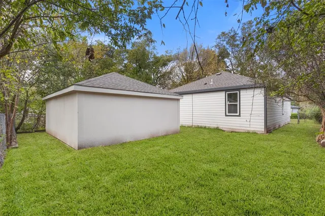 a view of a yard with a house and a tree