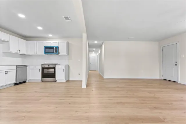 a view of a kitchen with a sink and a stove top oven