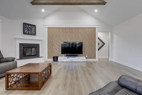 a living room with furniture and a fireplace