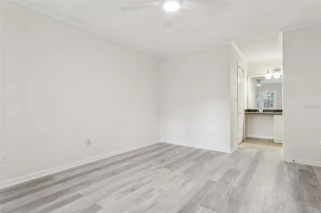 a view of empty room with wooden floor