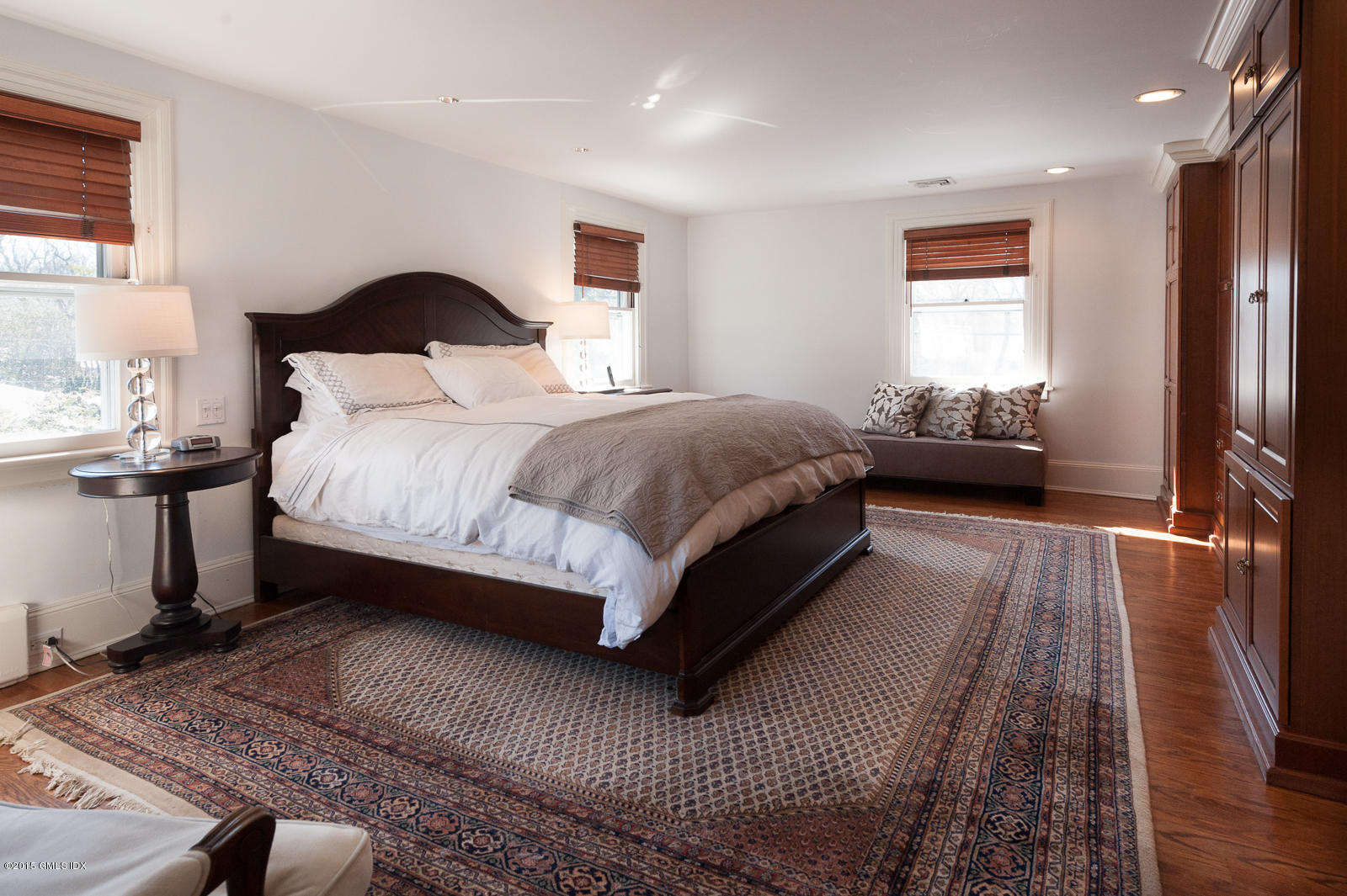 49 Indian Field Road Greenwich, CT 06830 - Photo 16 of 28 a bedroom with a bed lamp on desk and a window
