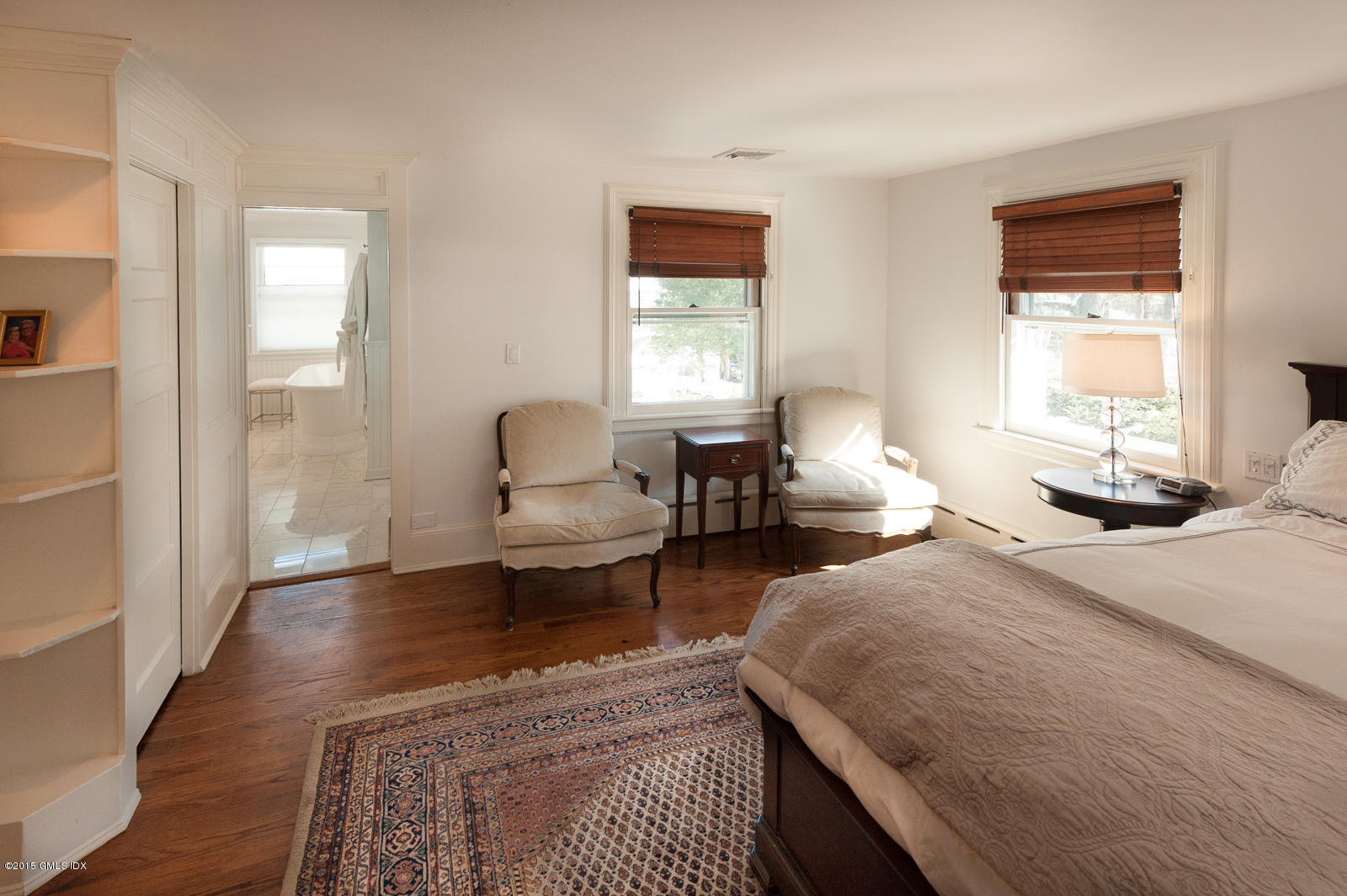49 Indian Field Road Greenwich, CT 06830 - Photo 17 of 28 a bedroom with a bed and wooden floor