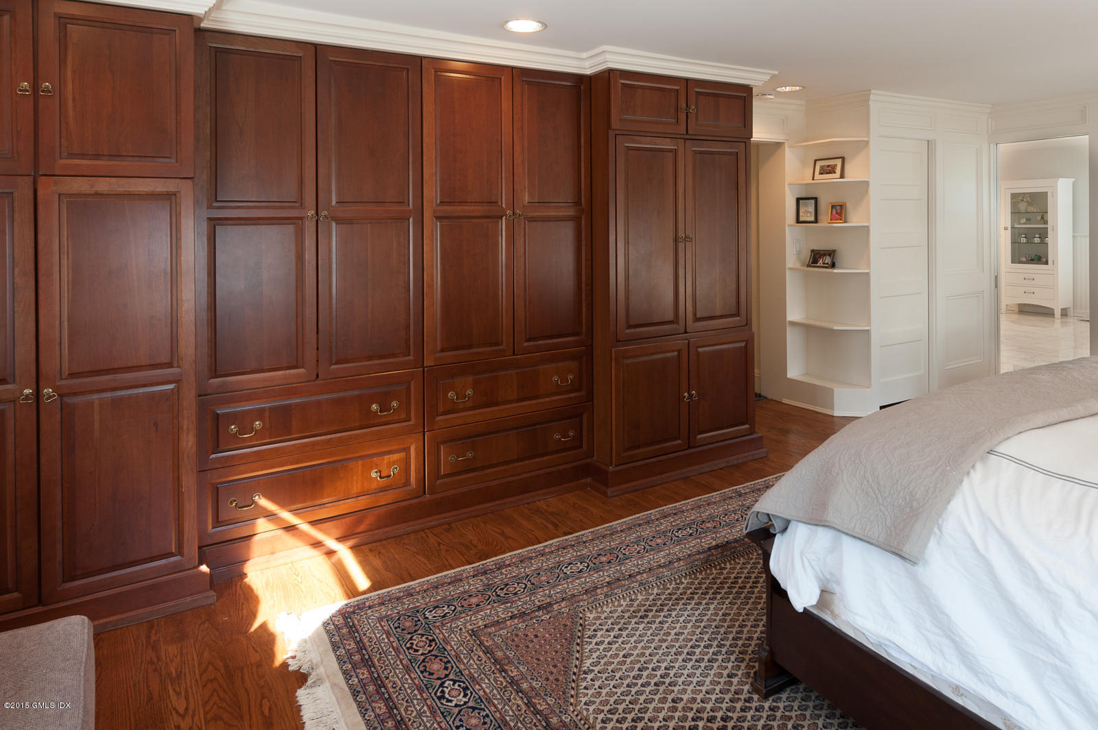 49 Indian Field Road Greenwich, CT 06830 - Photo 18 of 28 a bedroom with a bed and cabinets