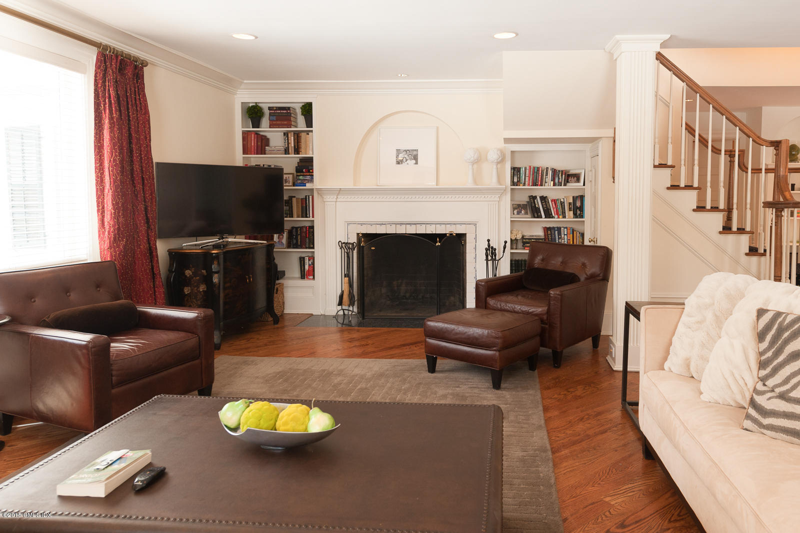 49 Indian Field Road Greenwich, CT 06830 - Photo 6 of 28 a living room with furniture a fireplace and a flat screen tv