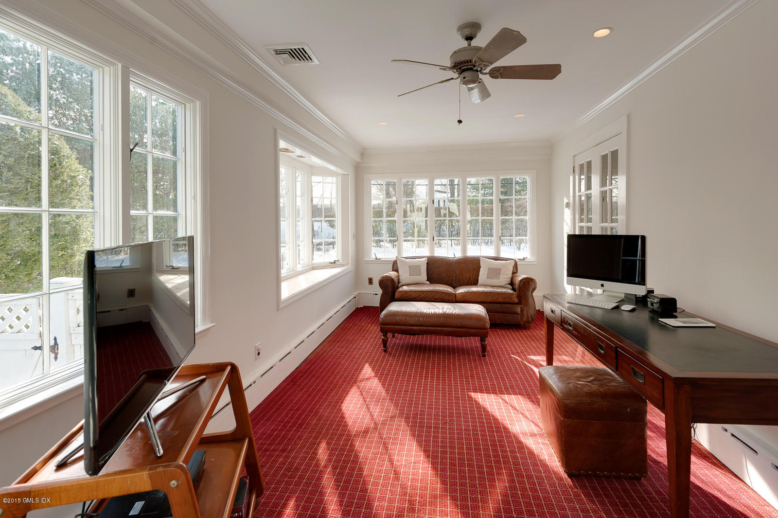 49 Indian Field Road Greenwich, CT 06830 - Photo 8 of 28 a living room with furniture a flat screen tv and a large window