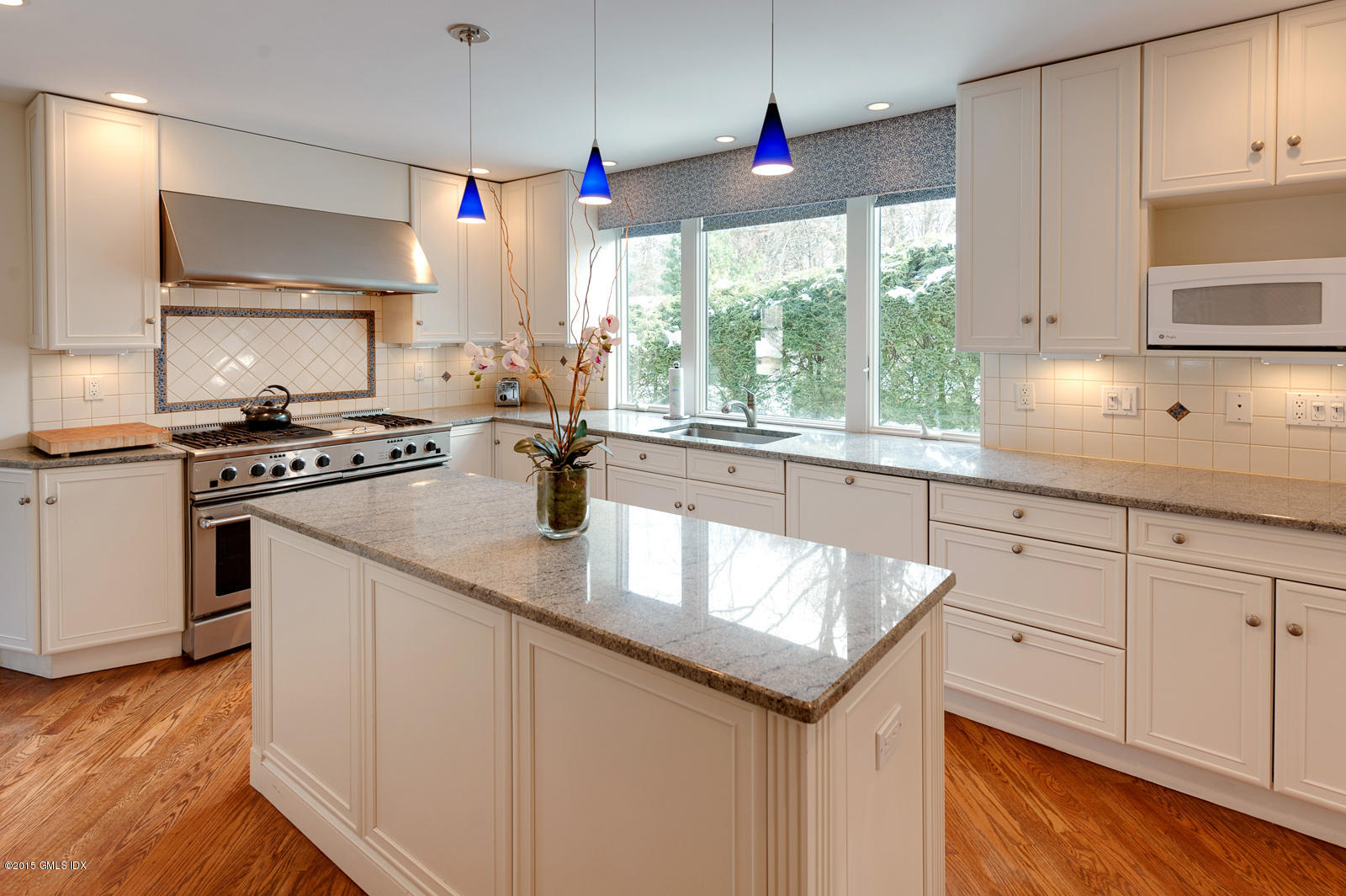 49 Indian Field Road Greenwich, CT 06830 - Photo 9 of 28 a kitchen with granite countertop a sink a counter space appliances and cabinets