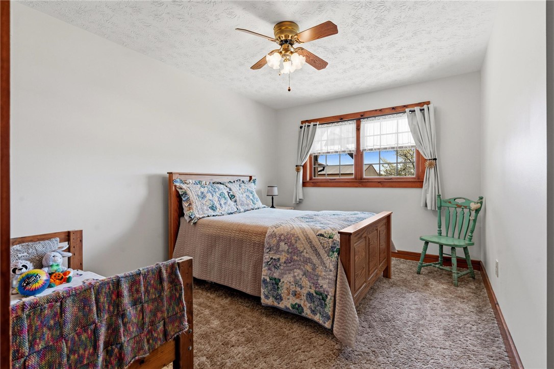 4971 Lackey Road Cedarville, OH 45314 - Photo 31 of 79 This cozy bedroom features a ceiling fan, carpet flooring, and ample natural light.