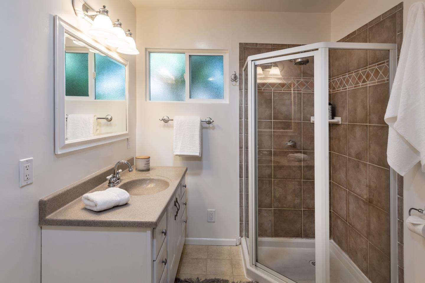 866 Stonehurst Way Campbell, CA 95008 - Photo 14 of 18 a bathroom with a sink vanity granite shower and a mirror