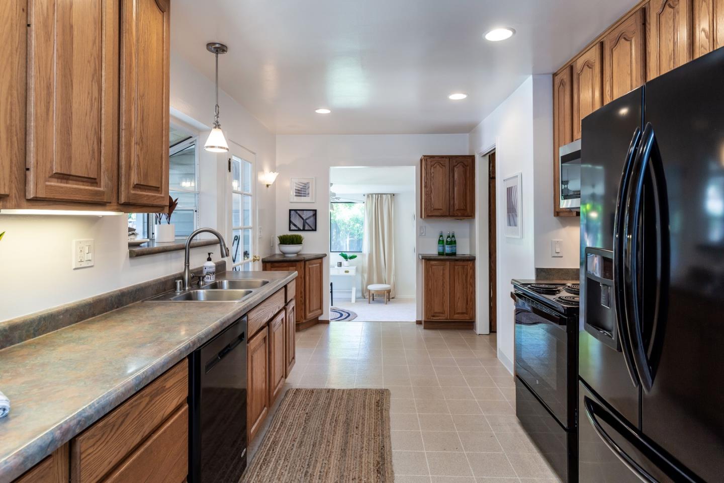 866 Stonehurst Way Campbell, CA 95008 - Photo 5 of 18 a kitchen with stainless steel appliances granite countertop a refrigerator a sink and a stove