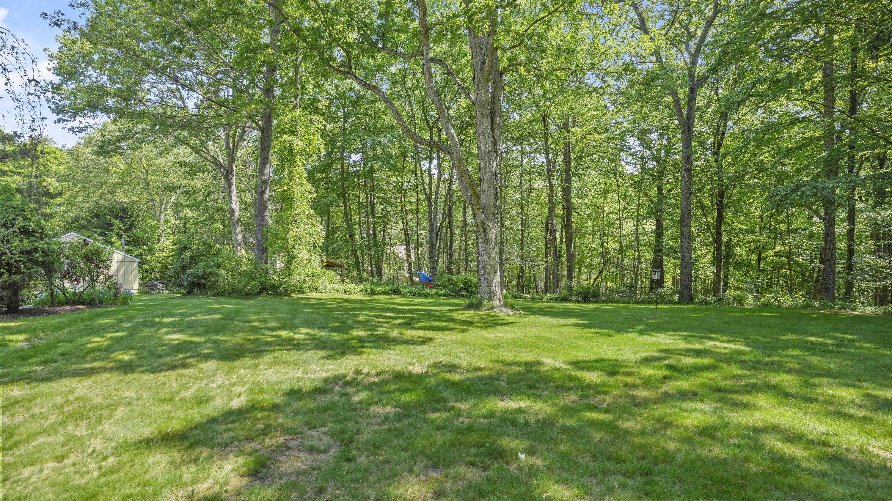 17 Middlebrook Pond Road Redding, CT 06896 - Photo 31 of 40 a view of a grassy field with trees in the background