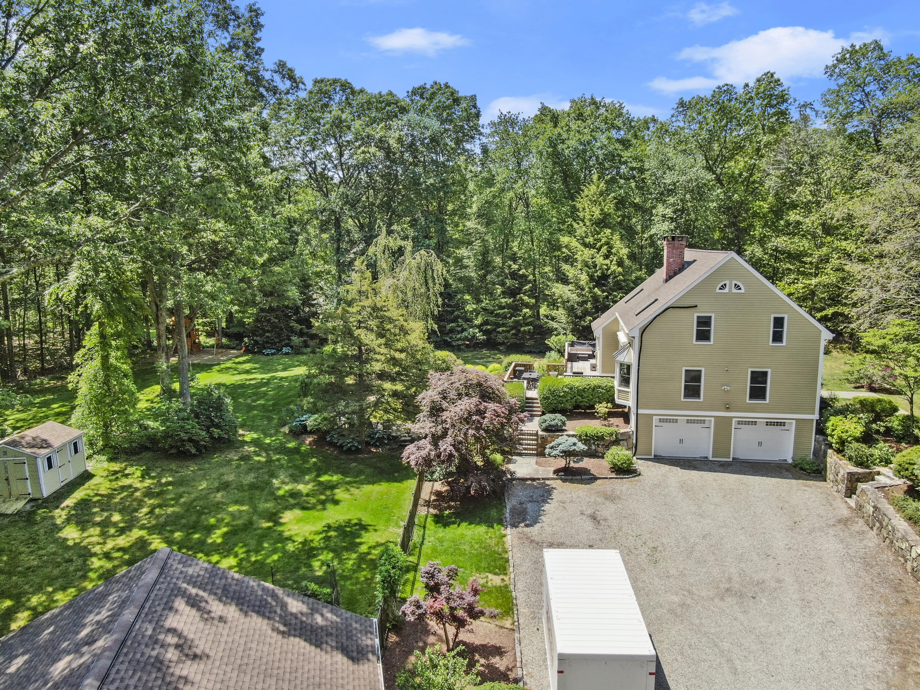 17 Middlebrook Pond Road Redding, CT 06896 - Photo 34 of 40 a front view of a house with a yard and a garden