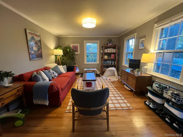 a living room with furniture a lamp and a window