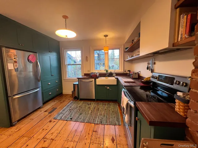 a stove top oven sitting inside of a kitchen