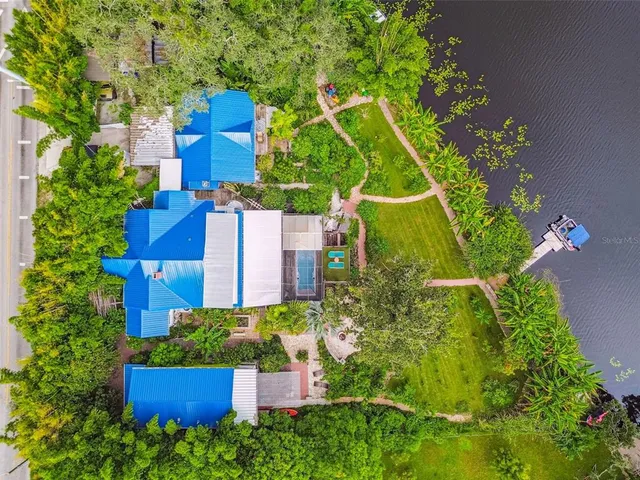 an aerial view of a house with a yard and potted plants