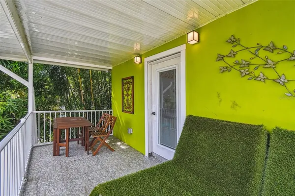 a view of a porch with wooden floor
