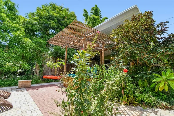 a living room with furniture a flat screen tv and a floor to ceiling window