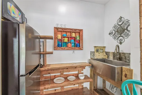 a large kitchen with stainless steel appliances granite countertop a lot of cabinets and wooden floor