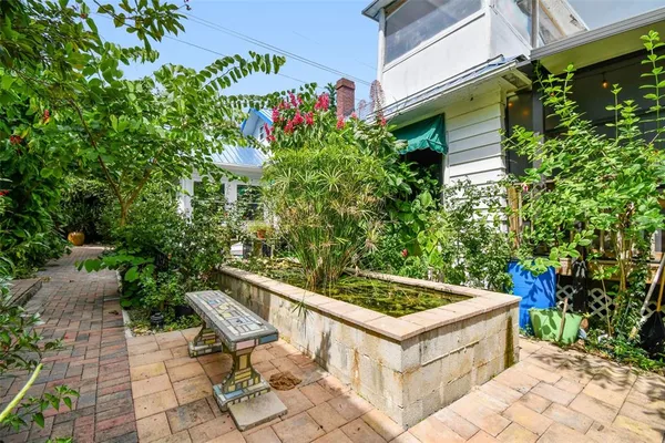 a bedroom with a bed and a chandelier fan