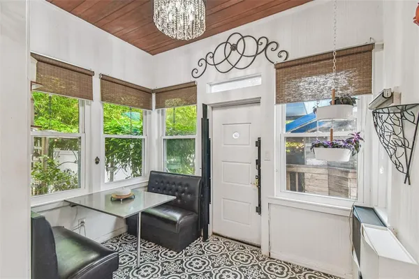 a large bedroom with a bed and wooden floor