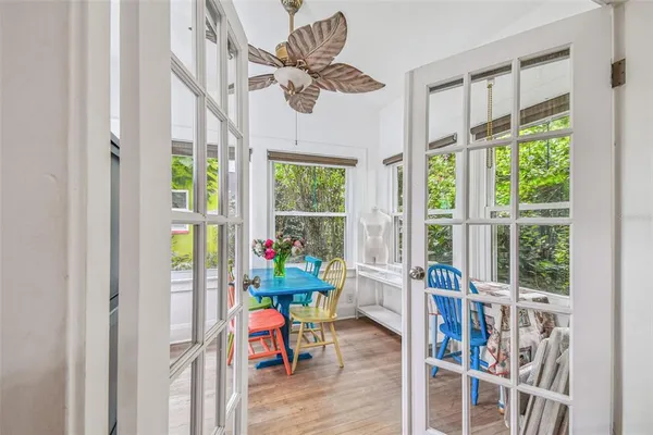 a dining room with furniture and a floor to ceiling window