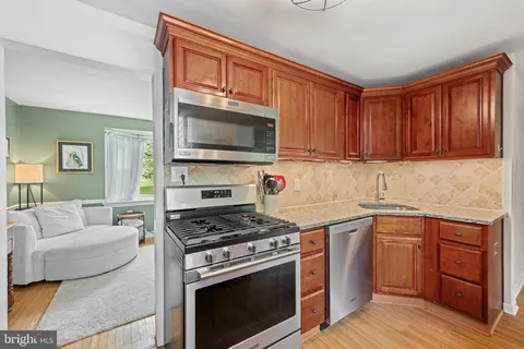 a kitchen with sink stove and cabinets