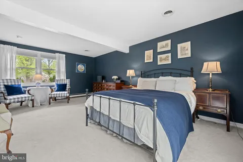 a bedroom with a bed and a lamp