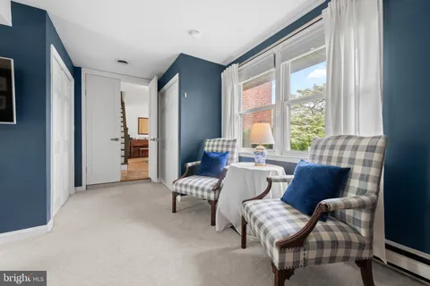 a living room with furniture and floor to ceiling windows