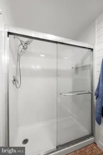 a bathroom with a glass shower door