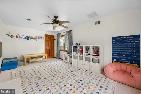 a bedroom with furniture and a book shelf