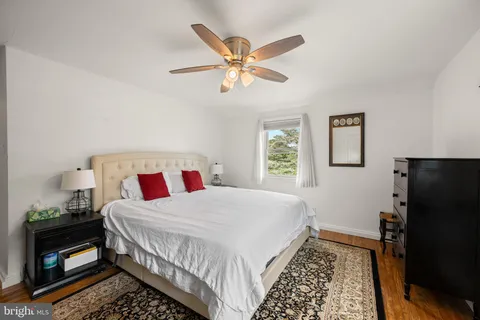 a bedroom with a bed and a ceiling fan