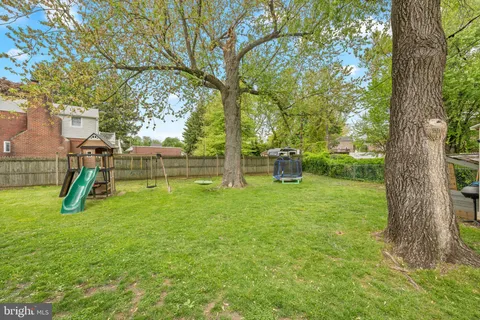 a view of a backyard with swings