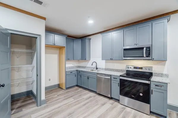 a kitchen with a sink stove and cabinets