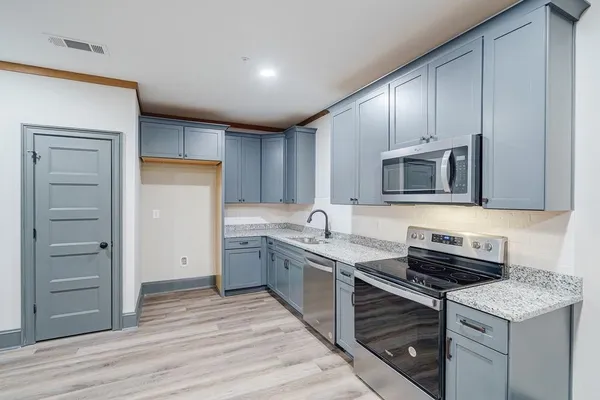 a kitchen with a sink stove and cabinets