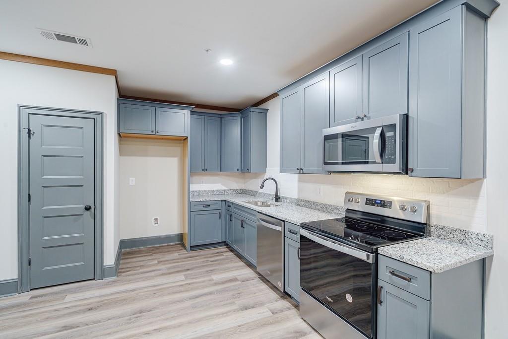 34 Depot Street, Unit 22 Hartwell, GA 30643 - Photo 17 of 29 a kitchen with a sink stove and cabinets