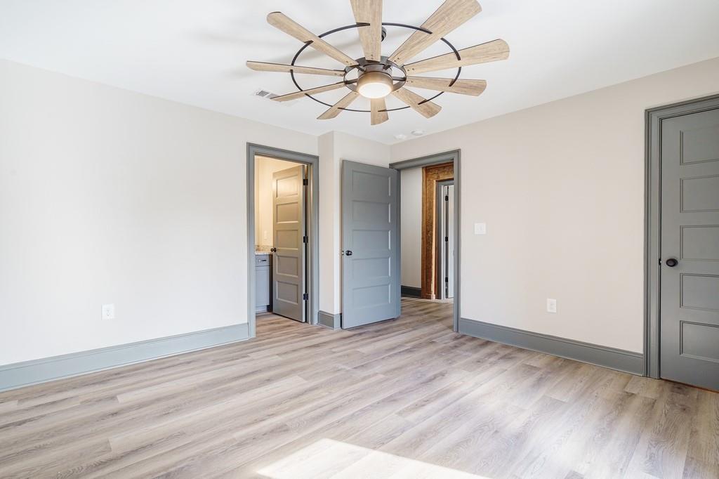 34 Depot Street, Unit 22 Hartwell, GA 30643 - Photo 20 of 29 an empty room with wooden floor fan and windows