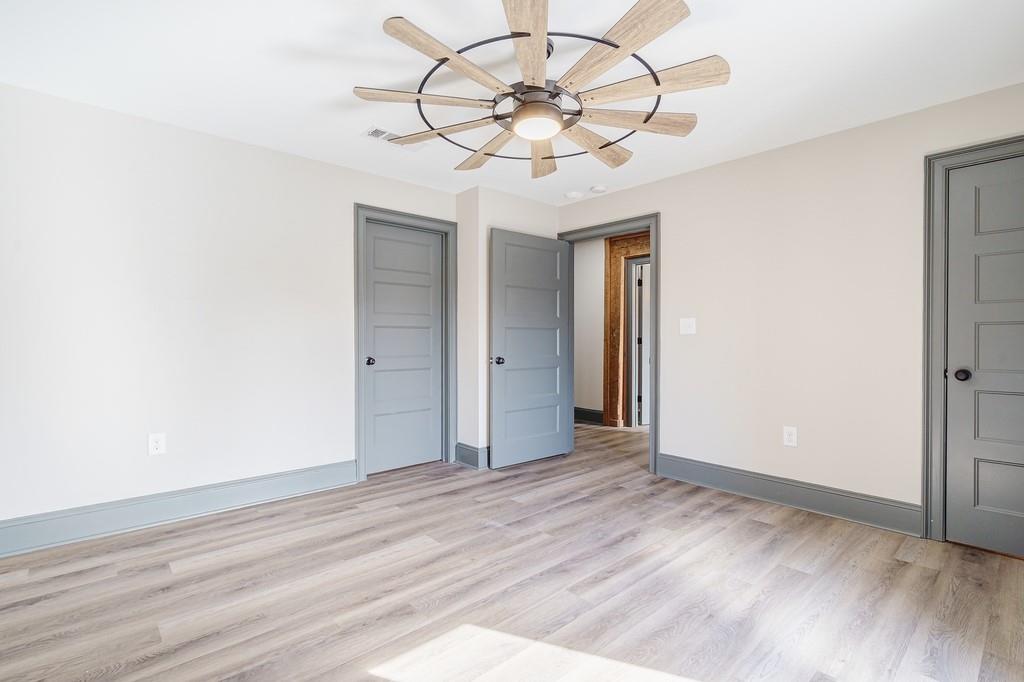 34 Depot Street, Unit 22 Hartwell, GA 30643 - Photo 21 of 29 an empty room with wooden floor fan and windows