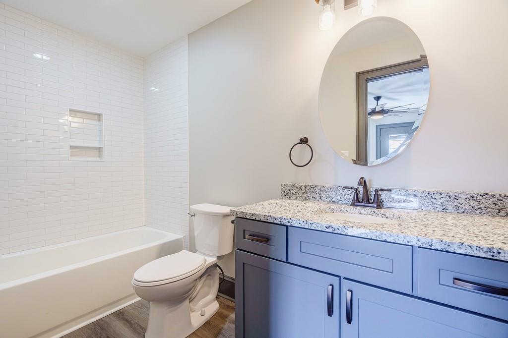 34 Depot Street, Unit 22 Hartwell, GA 30643 - Photo 23 of 29 a bathroom with a granite countertop toilet sink and mirror