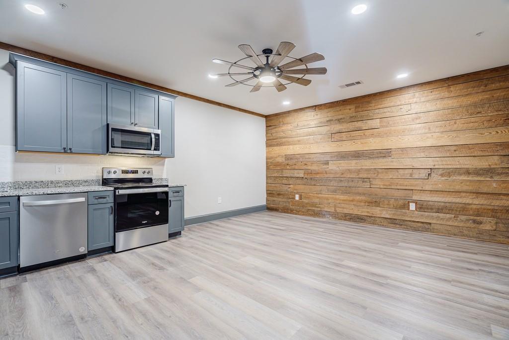 34 Depot Street, Unit 22 Hartwell, GA 30643 - Photo 6 of 29 a kitchen with granite countertop a stove and cabinets