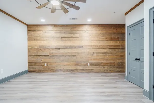 a view of walk in closet with empty racks
