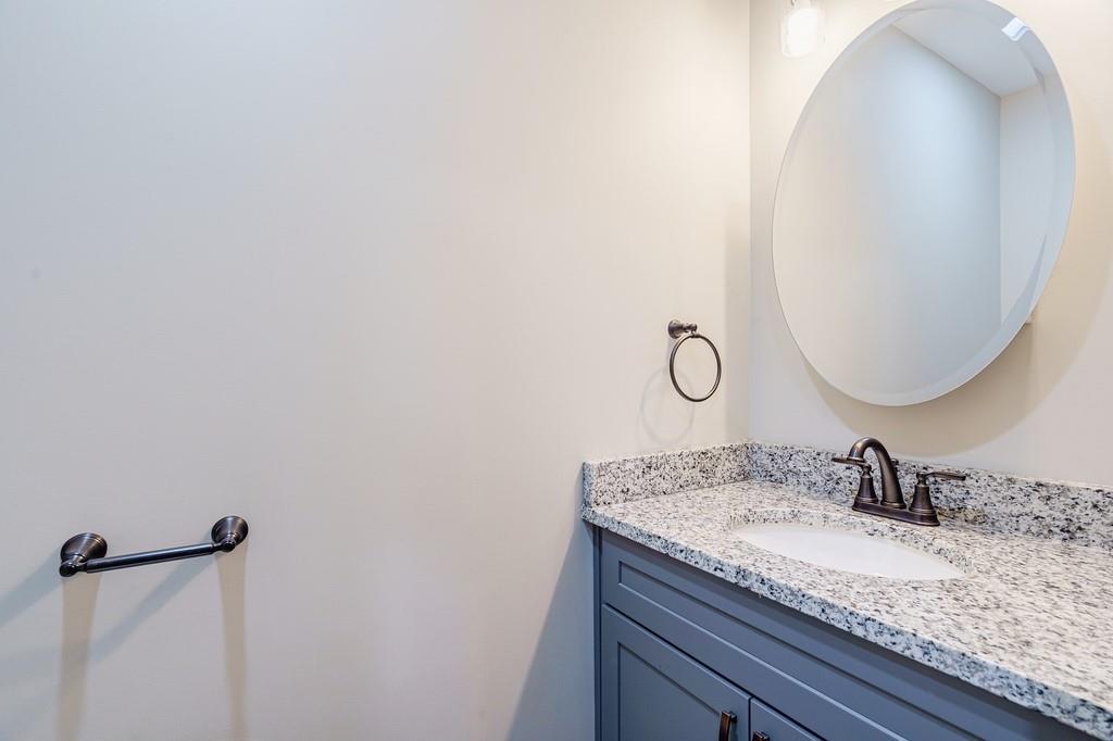 34 Depot Street, Unit 22 Hartwell, GA 30643 - Photo 9 of 29 a bathroom with a granite countertop sink and a mirror