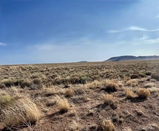 a view of a large building with mountains in the background