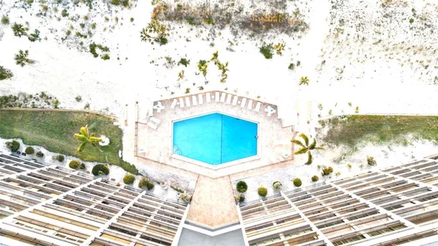 a view of a tennis ground with large trees