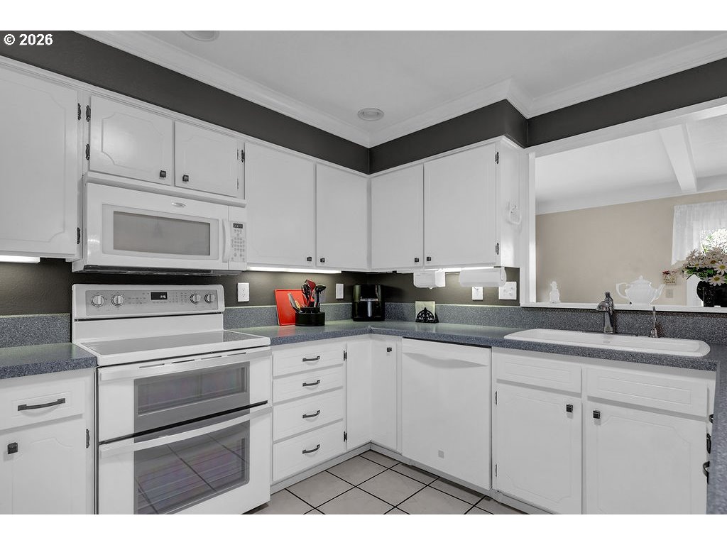 1415 20th Street Florence, OR 97439 - Photo 10 of 40 a kitchen with appliances cabinets and a sink
