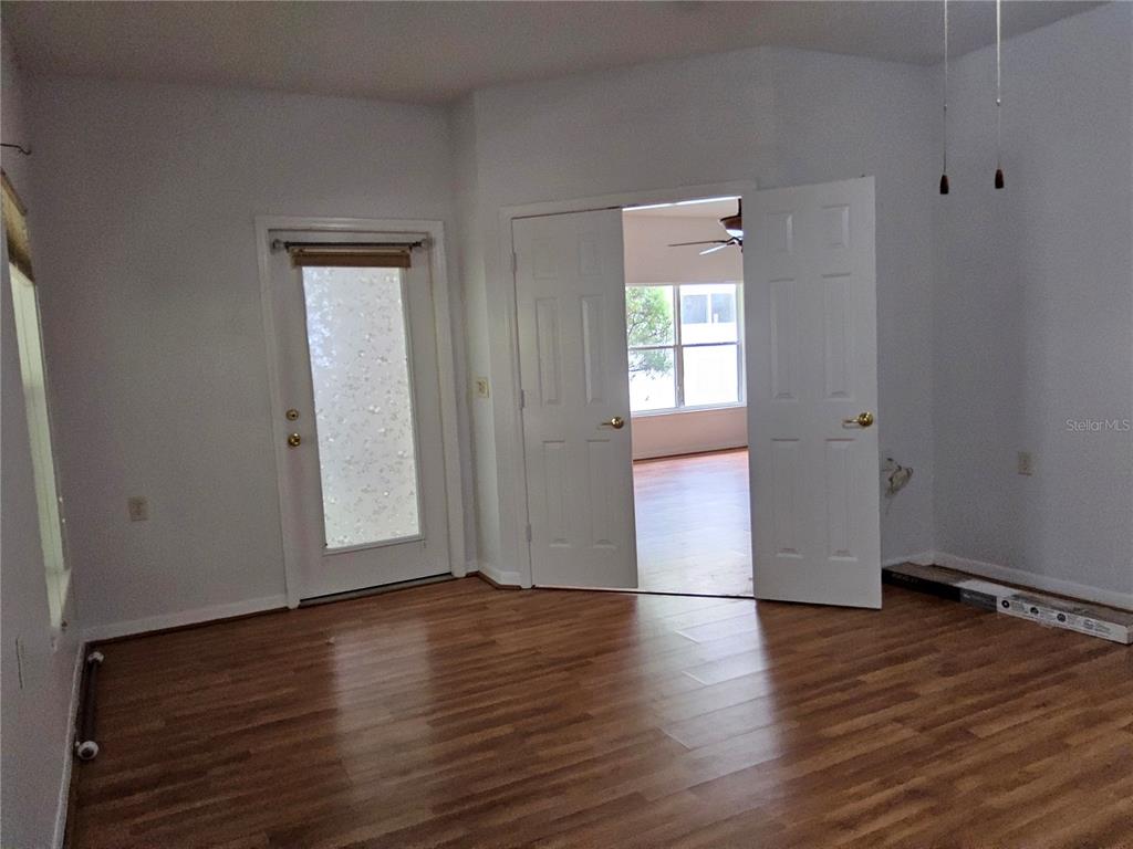 8023 St Andrews Way Mount Dora, FL 32757 - Photo 12 of 28 an empty room with wooden floor and windows