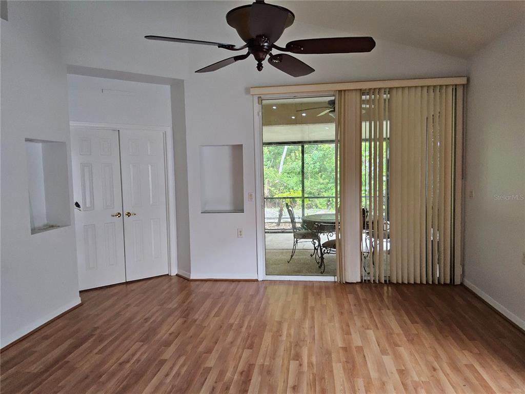 8023 St Andrews Way Mount Dora, FL 32757 - Photo 14 of 28 a view of empty room with wooden floor and fan