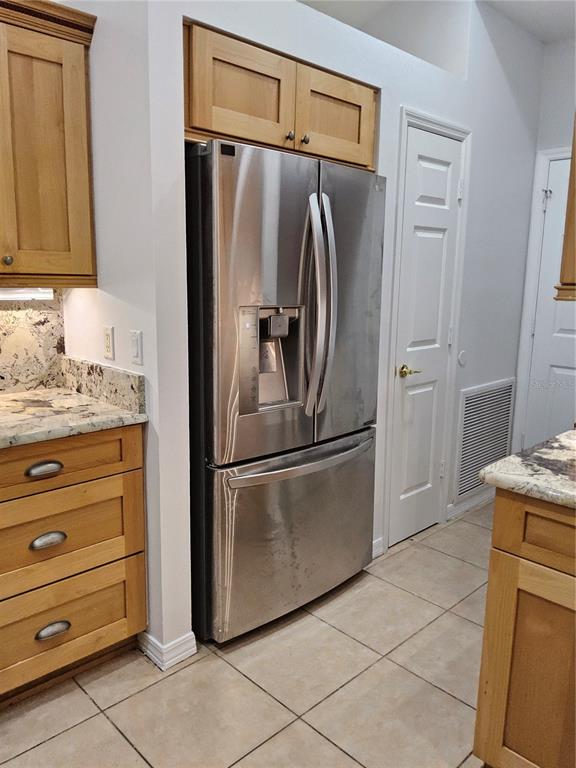 8023 St Andrews Way Mount Dora, FL 32757 - Photo 16 of 28 a kitchen with stainless steel appliances granite countertop a refrigerator and a sink