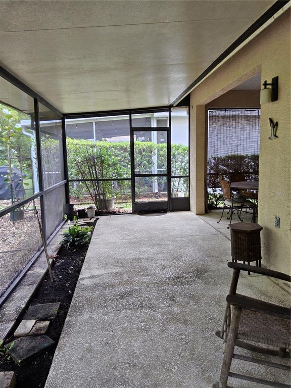 8023 St Andrews Way Mount Dora, FL 32757 - Photo 24 of 28 a view of a room with wooden floor and windows