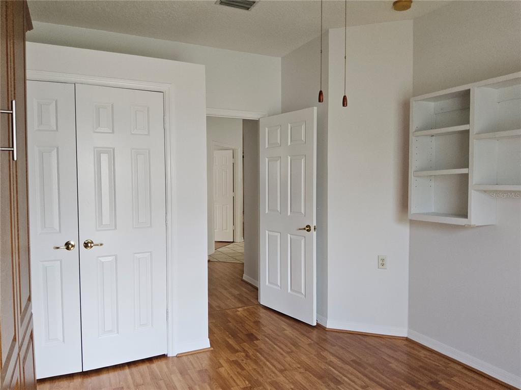 8023 St Andrews Way Mount Dora, FL 32757 - Photo 6 of 28 an empty room with wooden floor and closet area